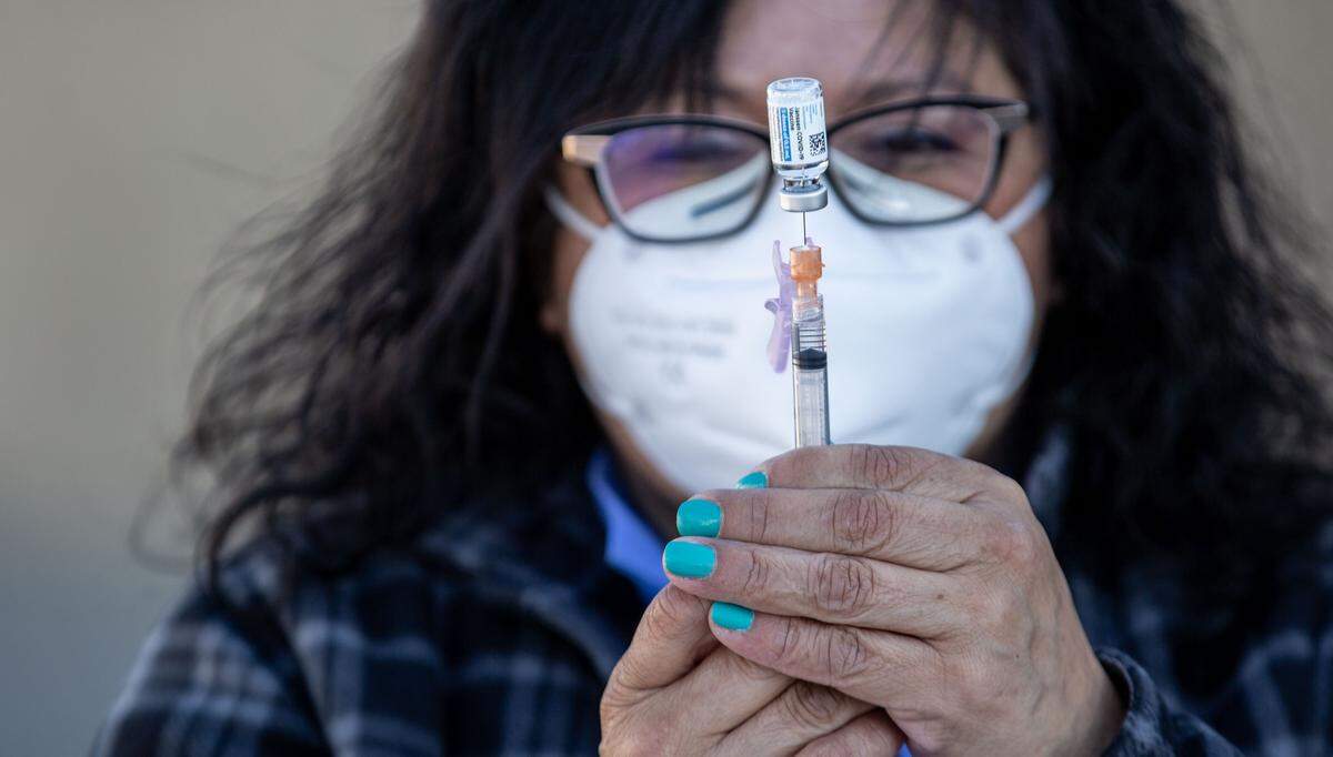 Pharmacy technician Elia Vargas prepares a dose of COVID-19 vaccination for Douglas Fruit workers Friday during a pop-up clinic outside of the company’s Pasco facility. The agricultural producer partnered with the Washington State Tree Fruit Association and Safeway/Albertsons to administer Johnson & Johnson’s Janssen single-dose vaccine to employees.
