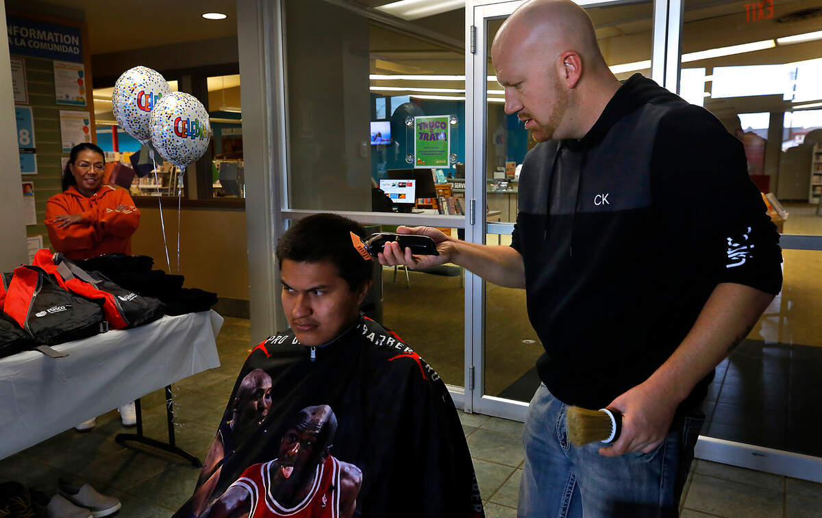 Barber Steven Kravarik of Exclusive Barber Shop in Pasco volunteers at the monthly Homeroom Connect Program. Among his free haircuts was one for Xavier Rodriguez, 19.