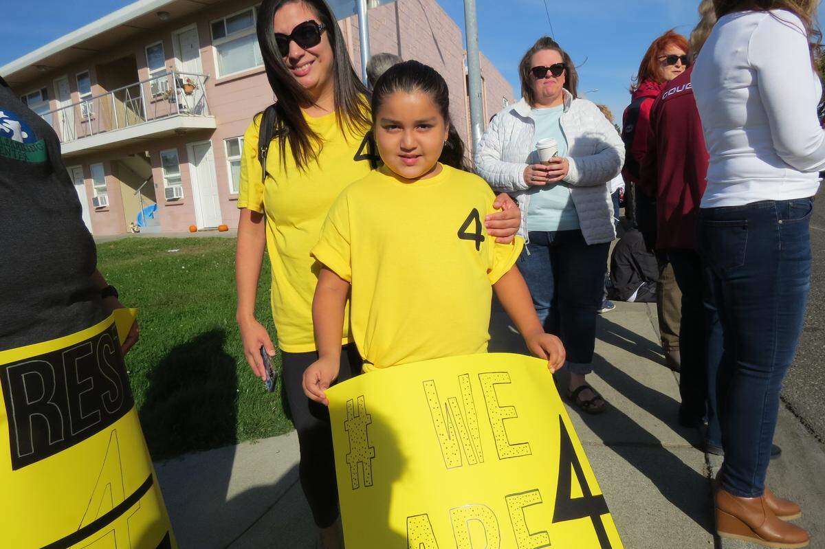Jessica and Jeselle Sandoval wore yellow shirts with “4” on them. The number of Dick Lenhart’s bus route for Longfellow Elementary School