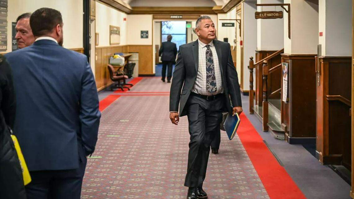 Former Pasco officer Richard Aguirre heads to court past prosecutors Larry Haskell, left, and Richard Whaley (back to camera), for his second murder trial, in the Spokane County Courthouse.