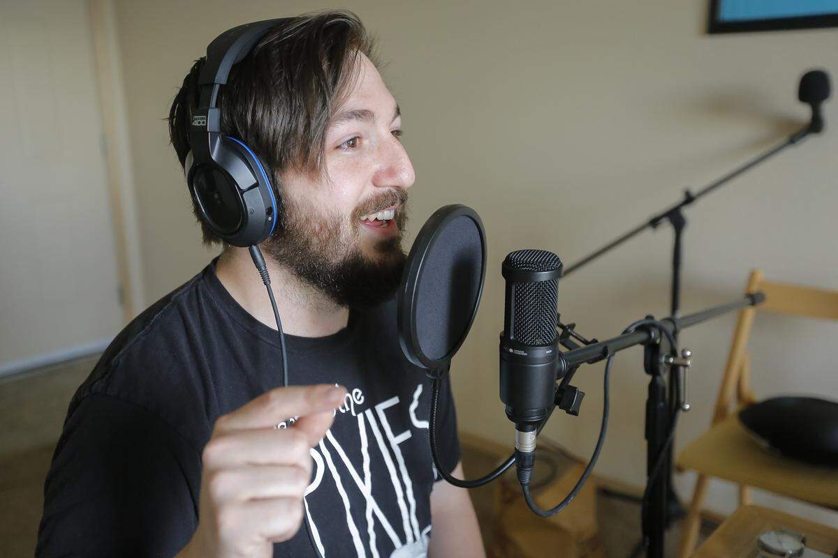 Jeffrey Graham talks into a microphone as he records an episode of Vanilla Sunday, a podcast that comes out weekly. 