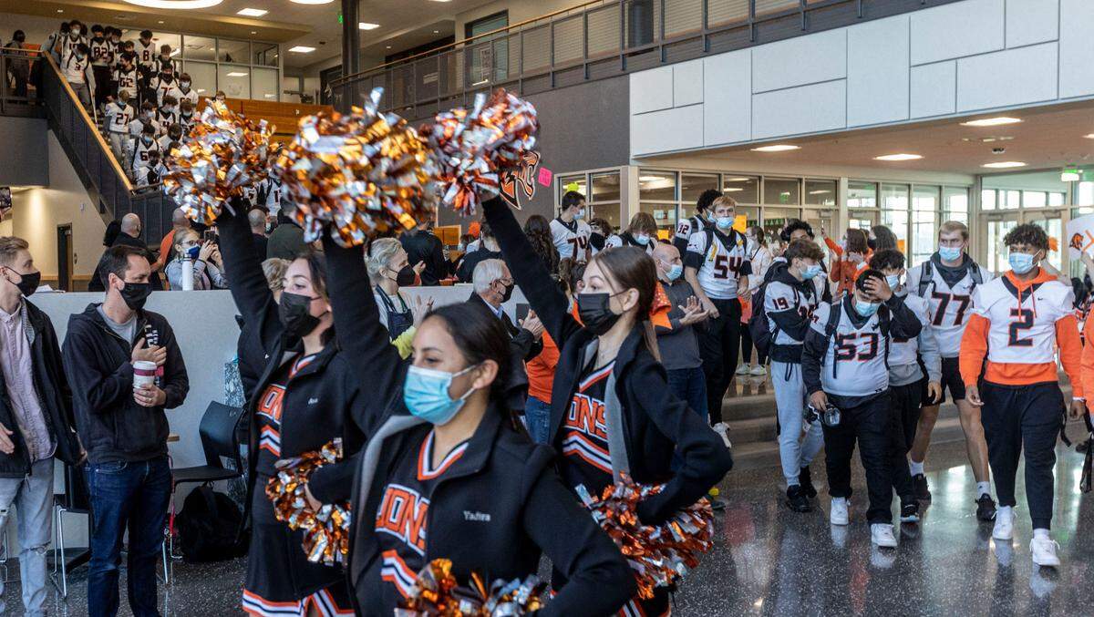 Students, faculty and staff wore masks as they gathered at Kennewick High School last month for a send-off of the Lions football team to state championships.