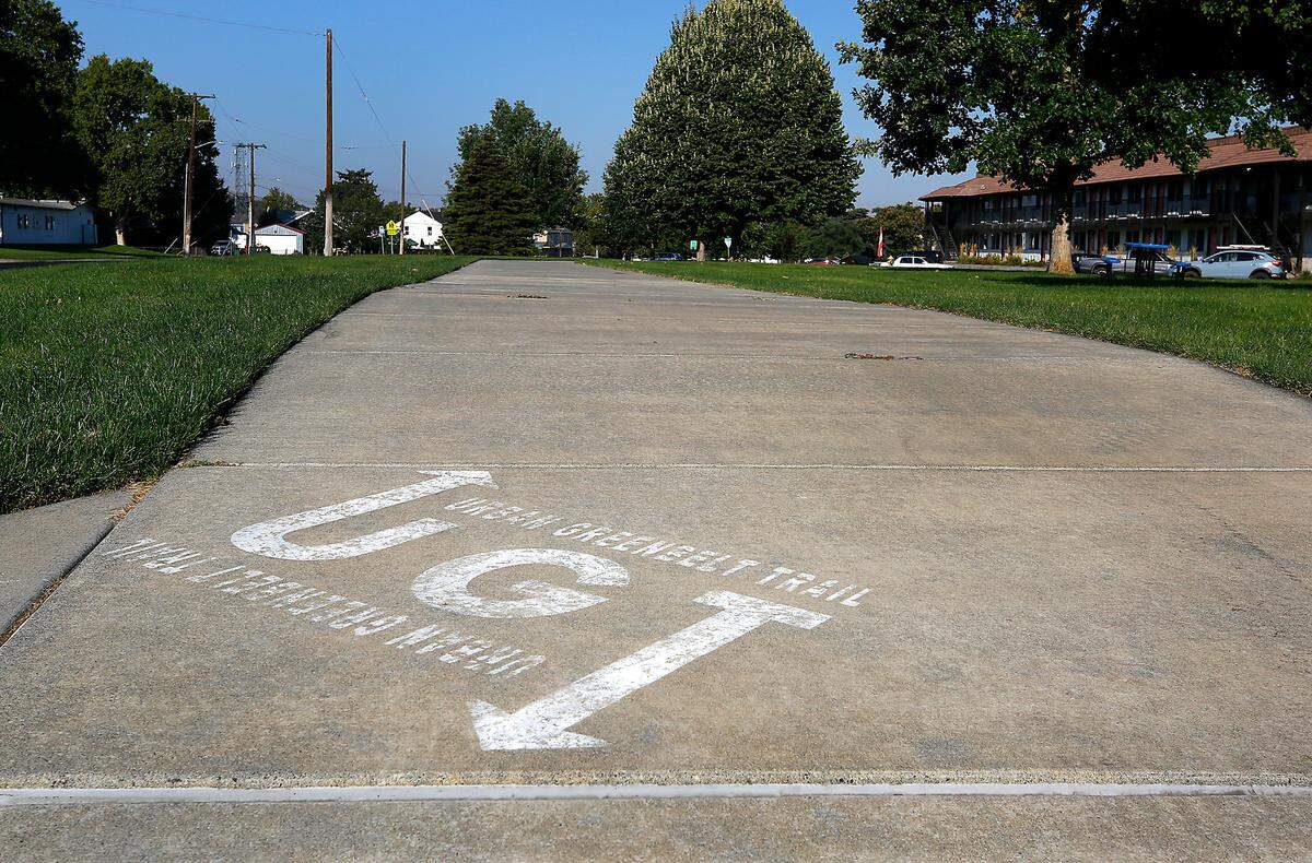 Markings for the Urban Greenbelt Trail are painted on the sidewalk near the intersection of Jadwin Avenue and Gillespie Street in Richland. The horseshoe shaped path that starts and ends at the Columbia River waterfront is now called the G.A. Pehrson Urban Greenbelt Trail.