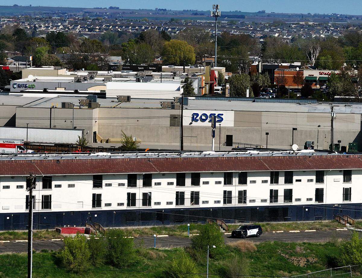 A Kennewick police cruiser patrols in the parking lot of the vacant former Motel 6 building off Highway 395 in Kennewick.