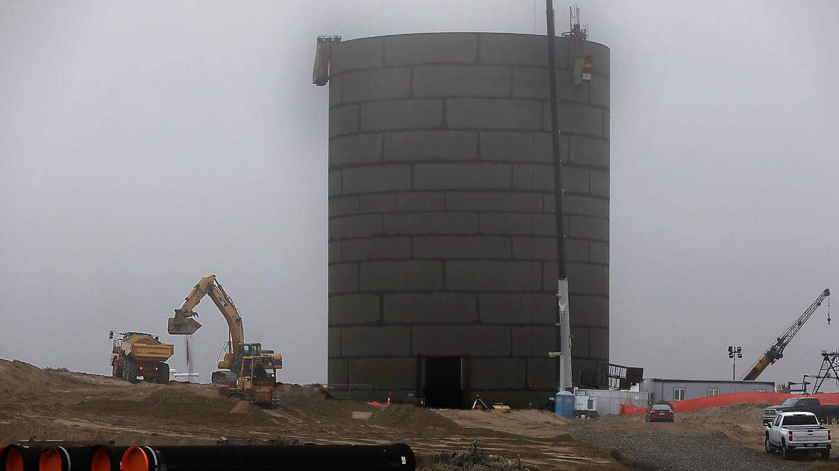 Construction crews work on building a new 3.5 million gallon 165-foot tall  water storage project to help meet increasing demand of new business and housing developments. 