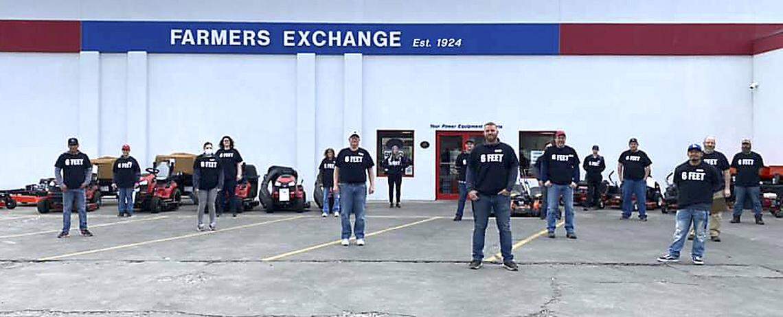 Farmers Exchange employees wear printed T-shirts that say “6 Feet” to remind customers and co-workers about social distancing during the coronavirus breakout.