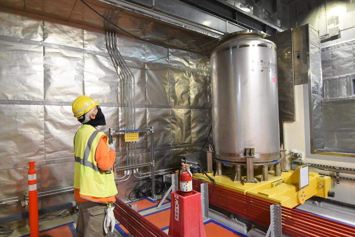 Electrician Ralph Bisla tests the line that moves containers before and after they are filled with glassified radioactive waste in the Low Activity Waste Facility of the Hanford vitrification plant.