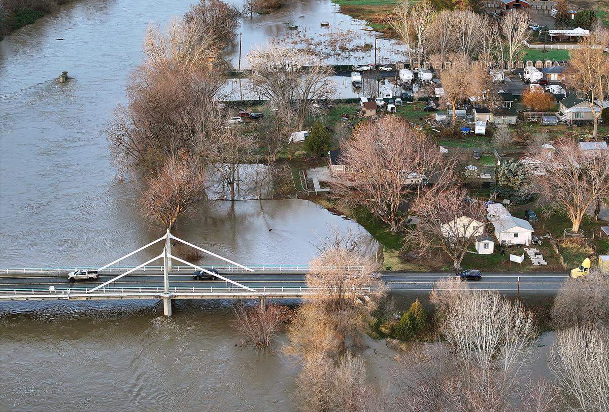 Traffic crosses over the swollen Yakima River Friday morning off Interstate 82 at Benton City.