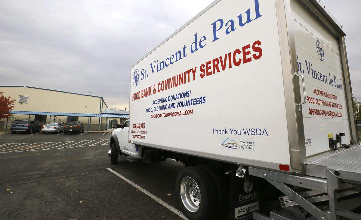 A delivery truck is parked outside the St. Vincent de Paul Food Bank and Community Services facility at 215 S. 6th Ave in Pasco.