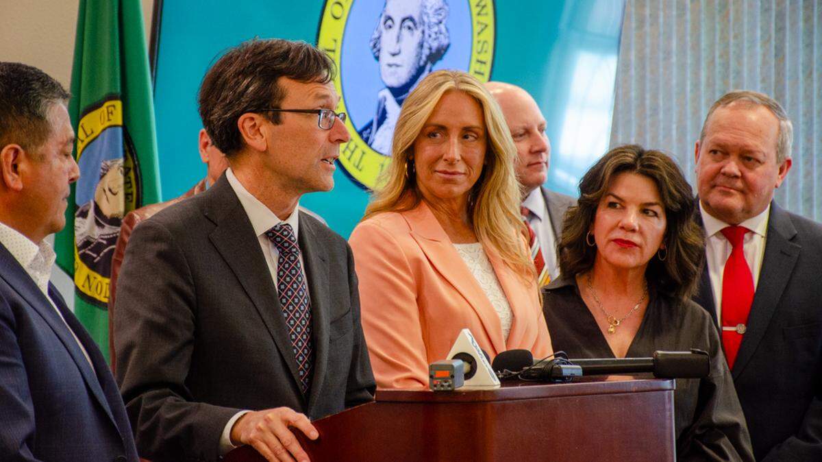 Gov. Bob Ferguson signs into law a bill expanding the ability of consumer-owned utilities to enter into joint agreements, as Tri-Cities Reps. Stephanie Barnard and April Connors and Sen. Matt Boehnke look on. It was sponsored by Rep. Alex Ybarra, R-Quincy.