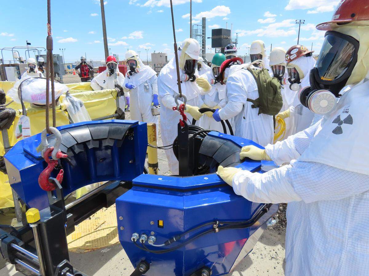 Hanford site crews prepare to install equipment in a radioactive waste storage tank to remove radioactive waste.