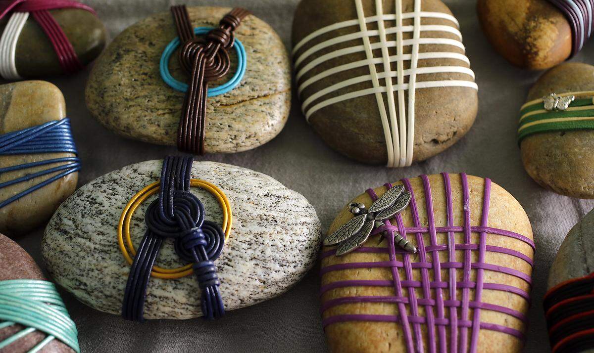 Rock painter Lynnette Gallegos and her husband, Joe, attended a community class to learn about rock wrapping from longtime Kennewick resident David Cross. 