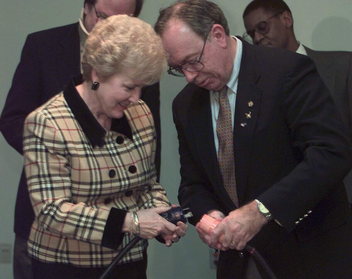State Sen. Pat Hale, R-Kennewick, left, and John Wagoner, then manager of Hanford operations, connect a ceremonial electrical cord at the dedication for the Columbia Basin College Workforce Training Center in 1997.