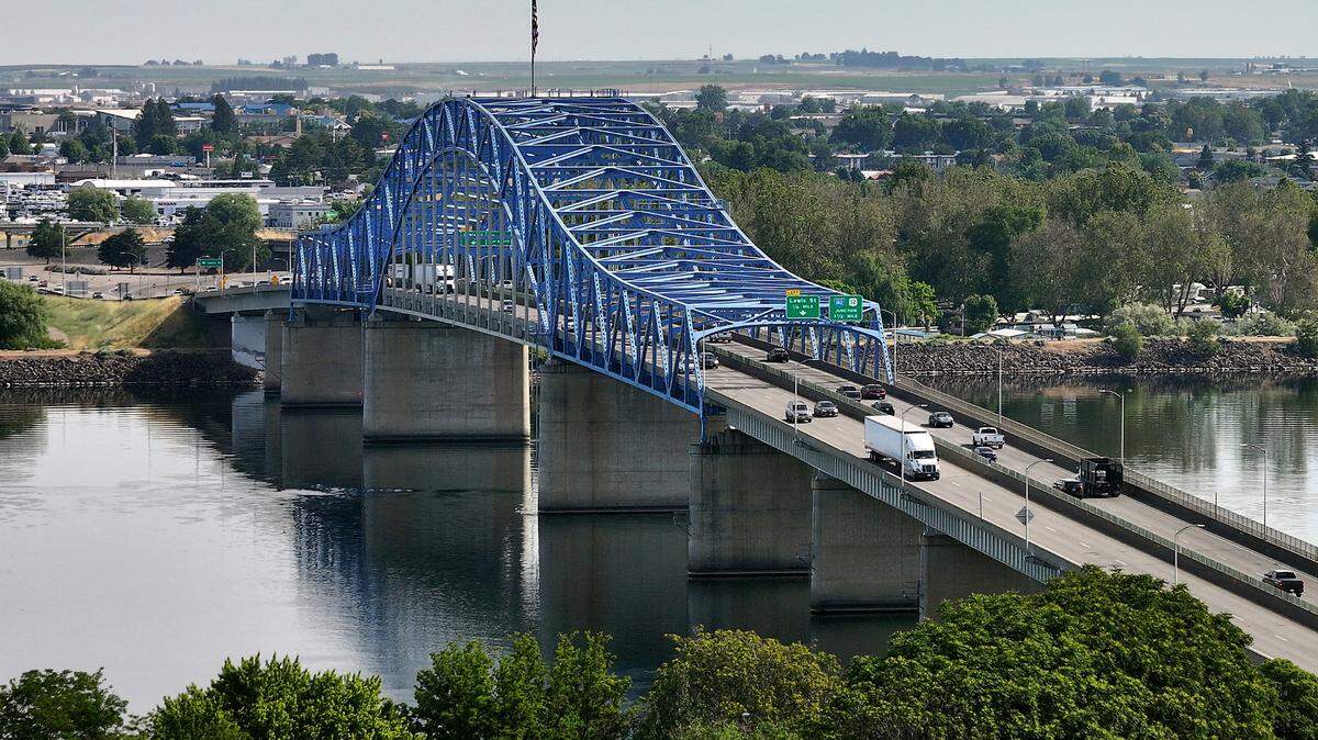 Traffic flows across the Pioneer Memorial blue bridge between Pasco and Kennewick over the Columbia River.