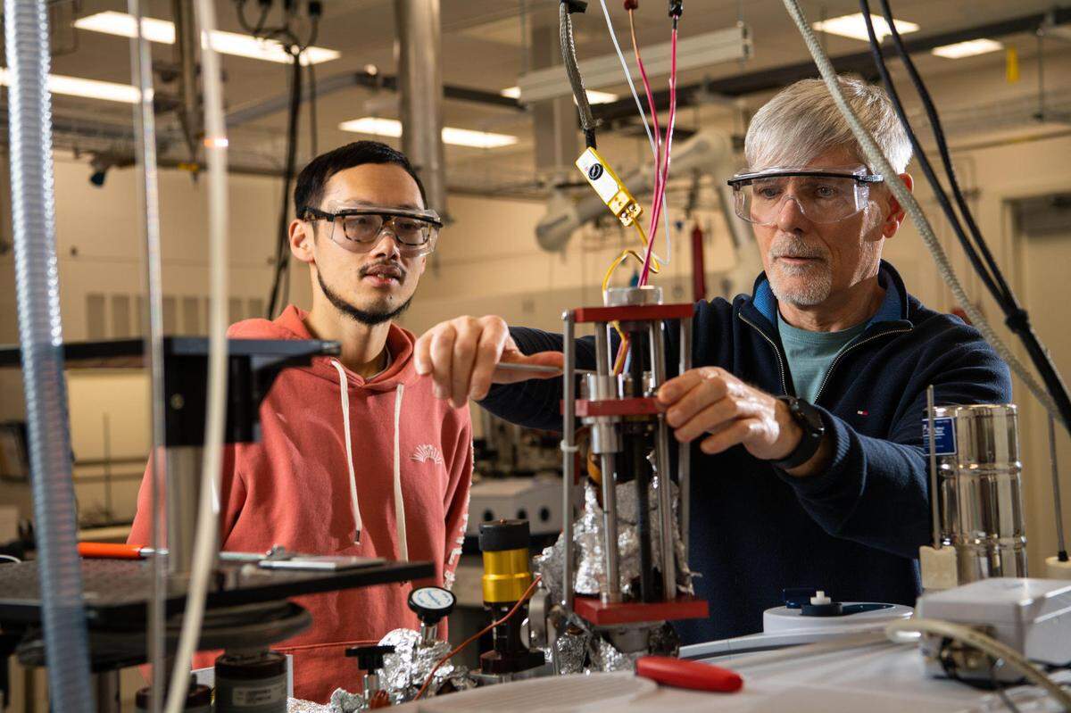 Chemist Janos Szanyi (right) led a team of researchers that included Linxiao Chen in discovering a promising approach to make it easier to turn petroleum-based plastic waste into chemicals that can be used to produce new materials and fuels.
