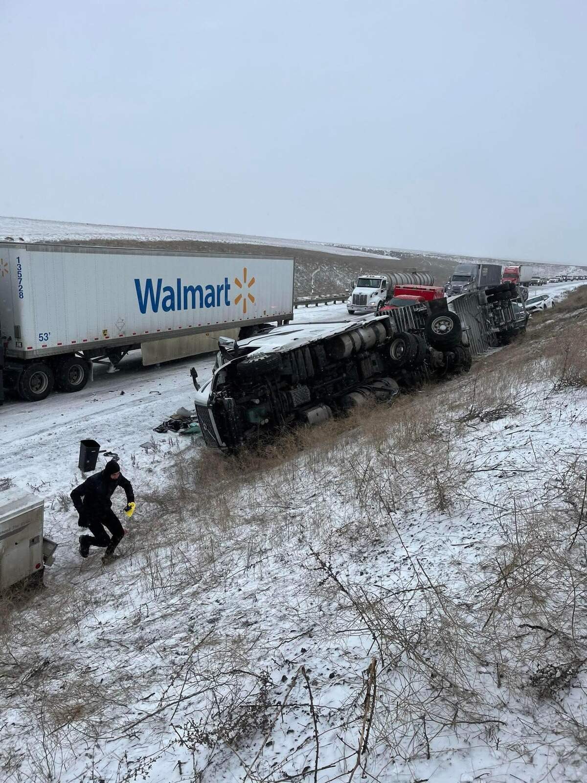 A semi truck ended up on its side in an 18-vehicle wreck in the snow in Benton County on Thursday Feb. 13, 2025. Two other semi trucks were also involved in the wreck.