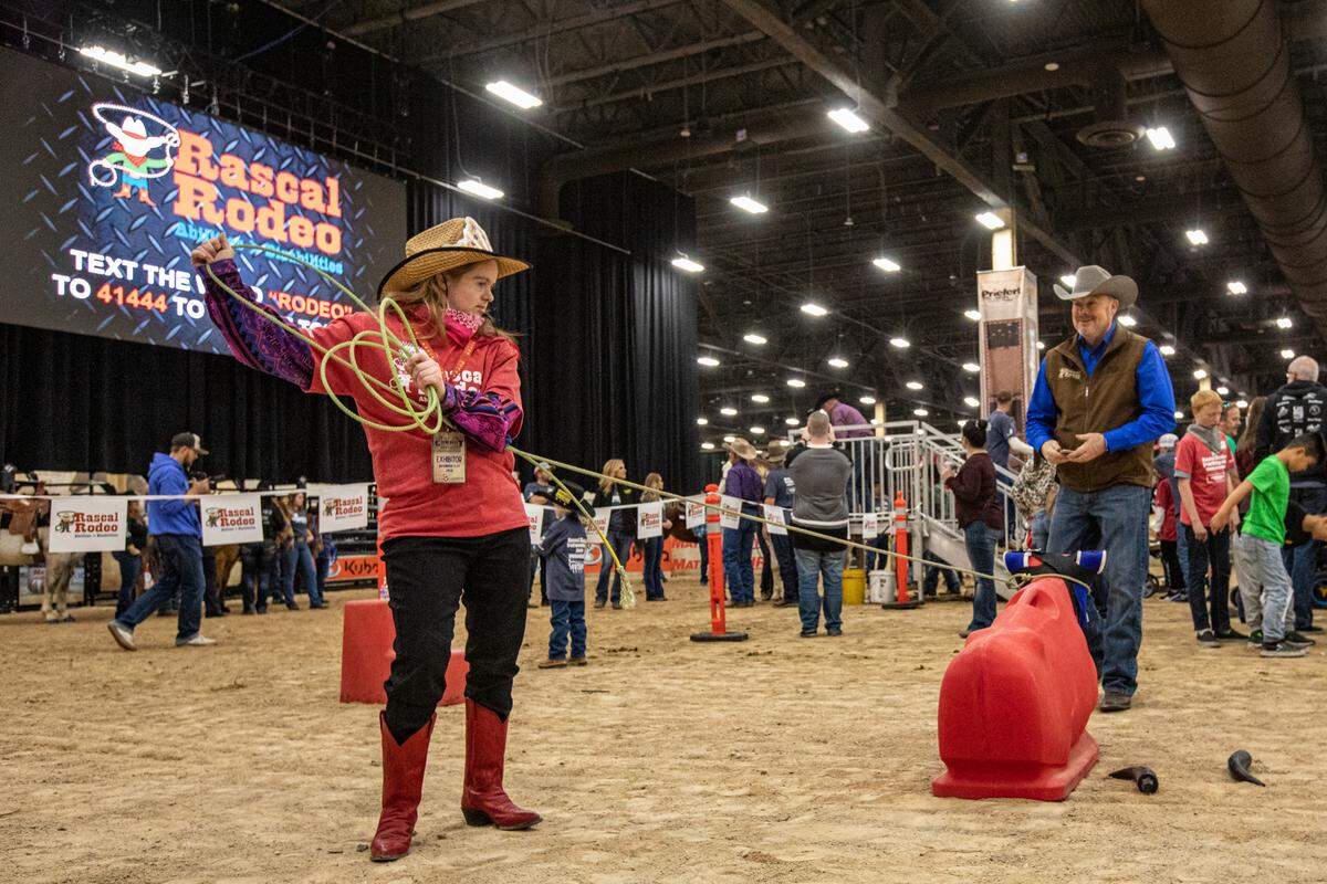 Rascal Rodeo board member Dan Whitsett, right, helps a participant in the steer roping at the 2019 Wrangler National Finals Rodeo in Las Vegas.