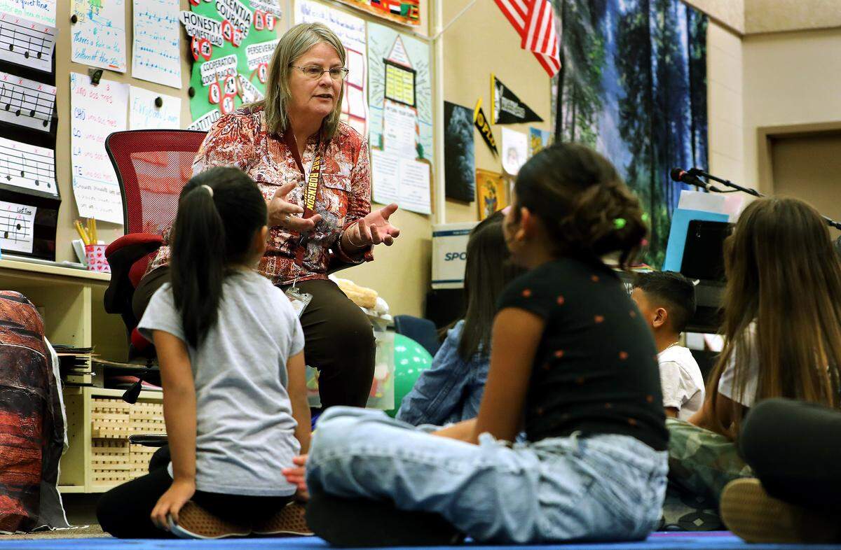 Music teacher Clarice Swanson speaks with students during an event at Virgie Robinson Elementary School in Pasco.