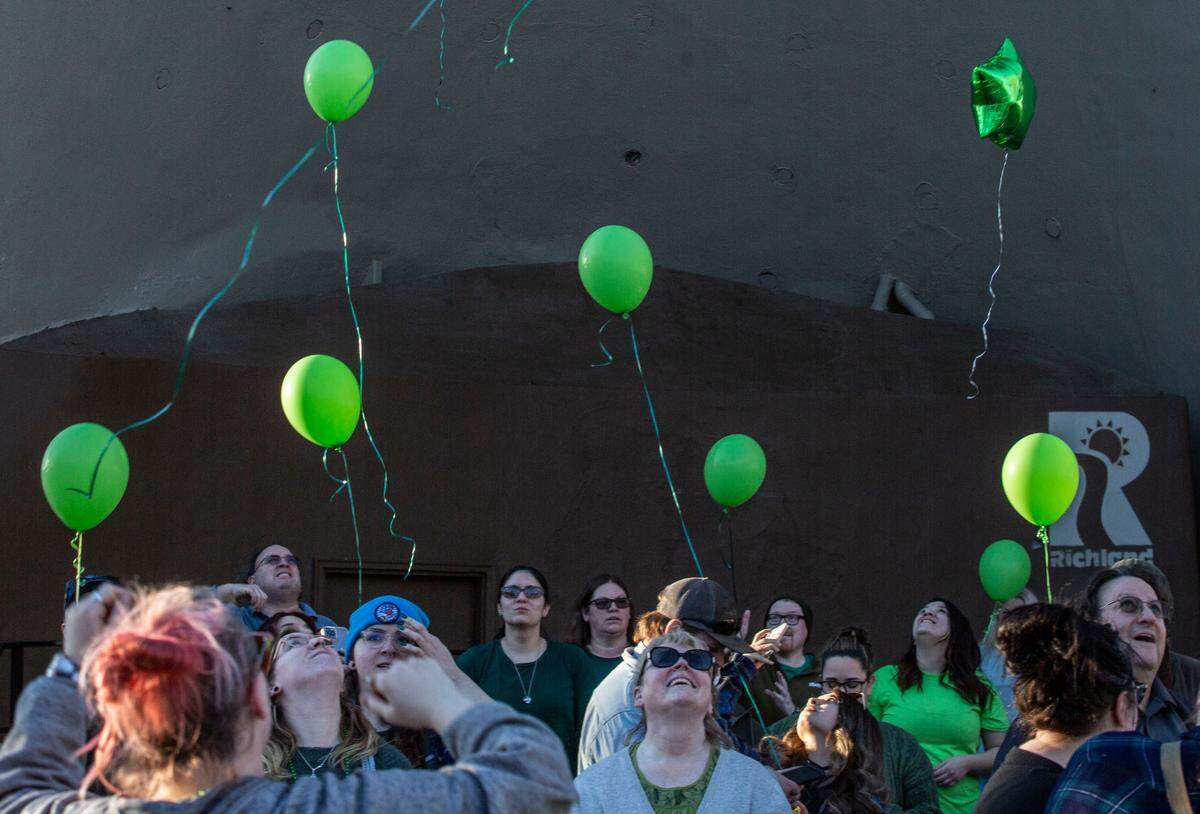 Balloons are released by friends and family during a memorial for Justin Krumbah in Howard Amon Park in Richland on Thursday.