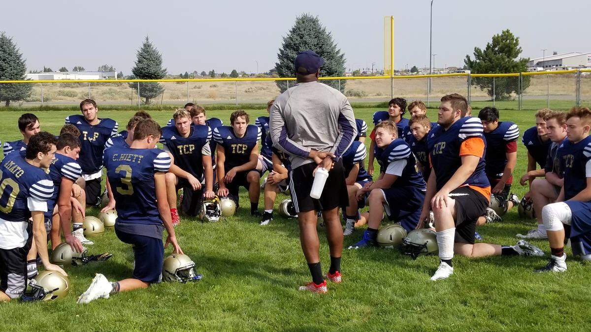 Tri-Cities Prep assistant coach Dennis Kennedy addresses the players after practice. The Jaguars open their season Friday against Liberty Christian.