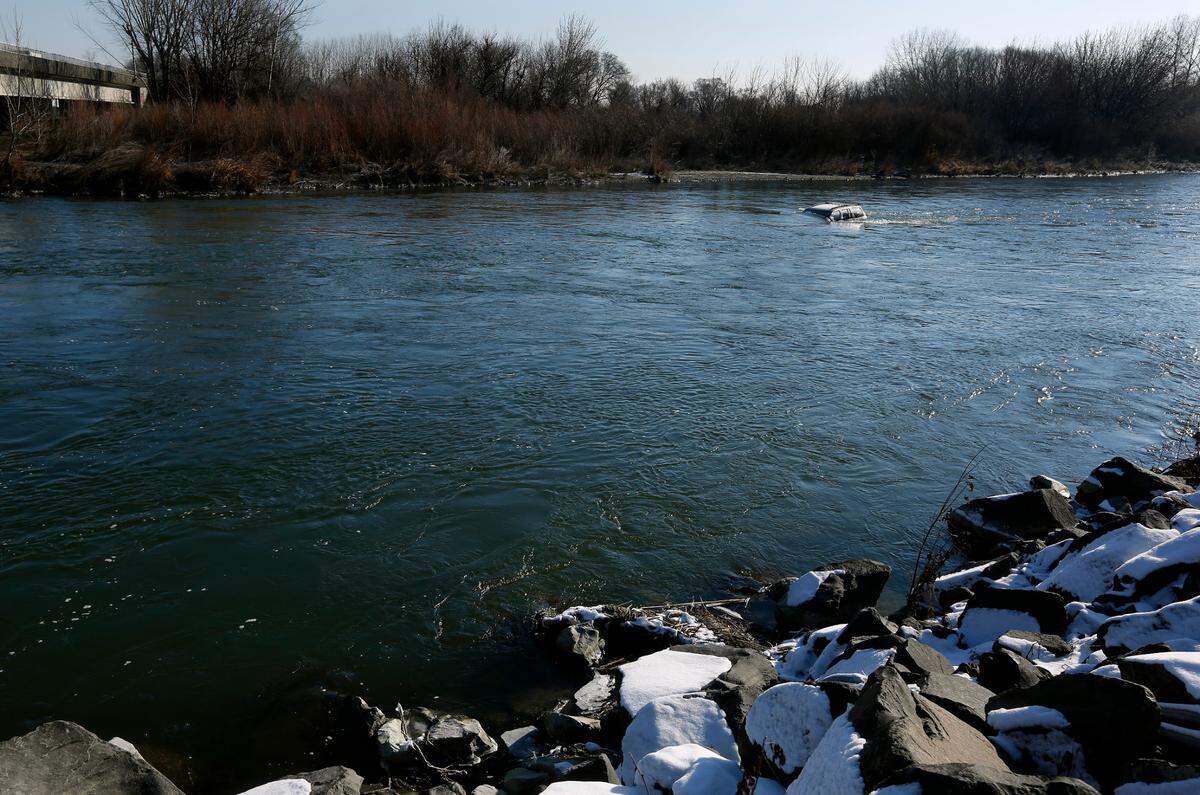 A Jeep SUV is submerged in the Yakima River just downriver of the Van Giesen Street bridge near West Richland.