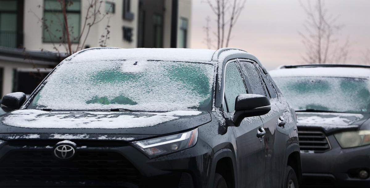 An overnight dusting of snow sticks to windshields of cars parked outside early Friday morning across the Tri-Cities region.