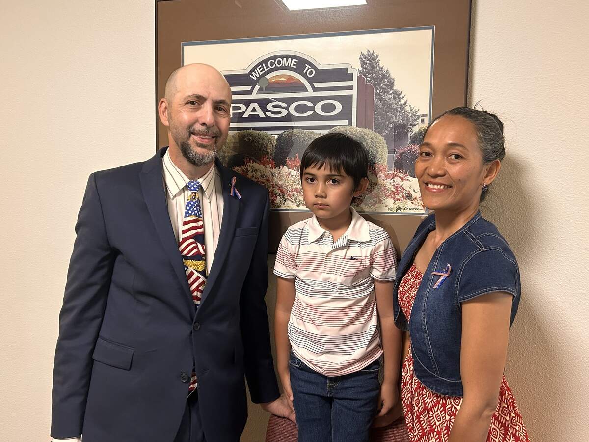 Bob and Marisol Mangione, with their son, attend a Pasco council meeting before asking council members to approve new regulations for short-term rentals.
