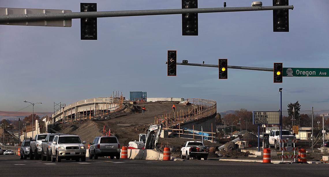 Eastbound traffic on Lewis Street waits at the traffic signal at Oregon Avenue near the east end of the new Lewis Street overpass in Pasco.