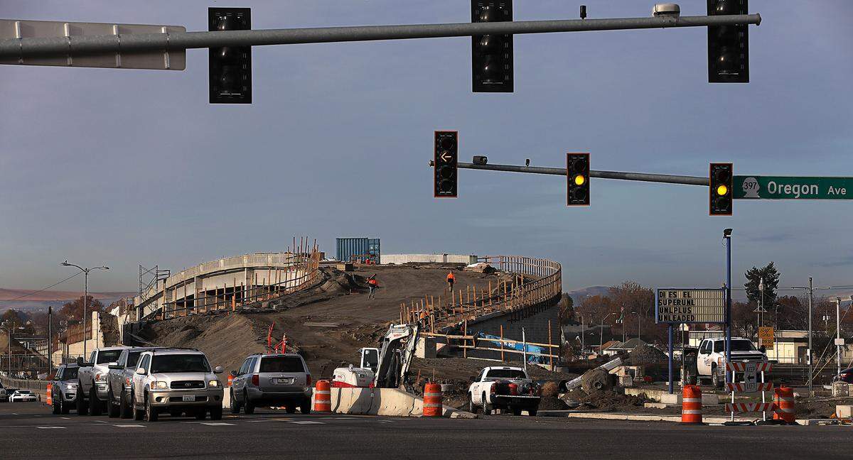 Eastbound traffic on Lewis Street waits at the traffic signal at Oregon Avenue near the east end of the new Lewis Street overpass in Pasco.