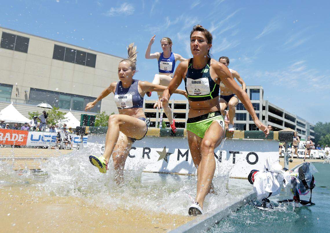 Marisa Howard, left, runs through the water in the women’s 3000-meter steeplechase at the U.S. Track and Field Championships, in 2017 in Sacramento, Calif.