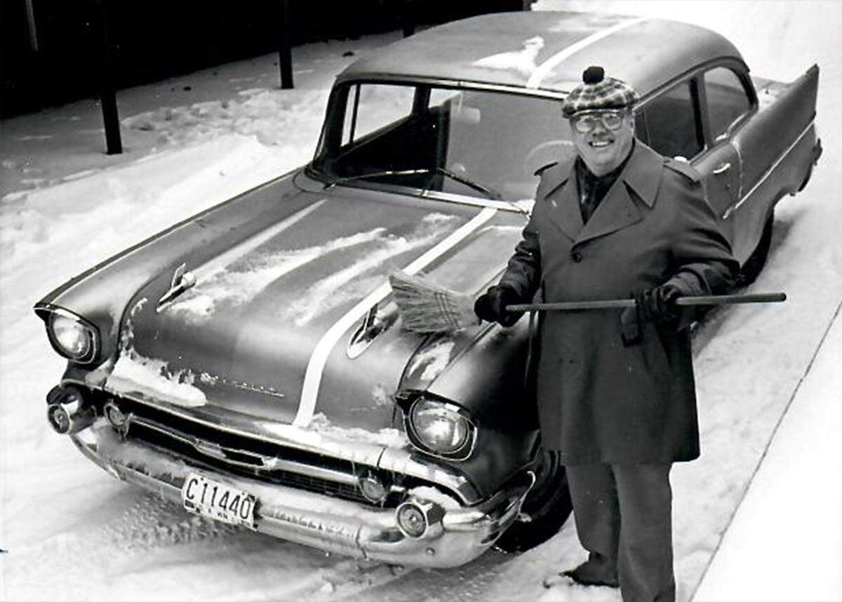 Jim Rabideau brushes snow off “Car Beautiful” the 1957 Chevy he picked to use as his county work car and had painted Bulldog purple with a white racing stripe.
