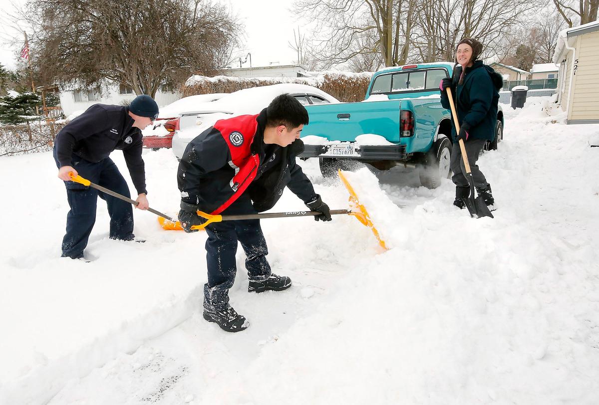 Assistant Fire Chief Erik Mattox, left, and firefighter Isidro Diddens, with Walla Walla Fire District 5 in Burbank, help dig paths for Jody Toebe after snow blocked her driveway. She asked to borrow a snow shovel but the firefighters walked over and dug her out.