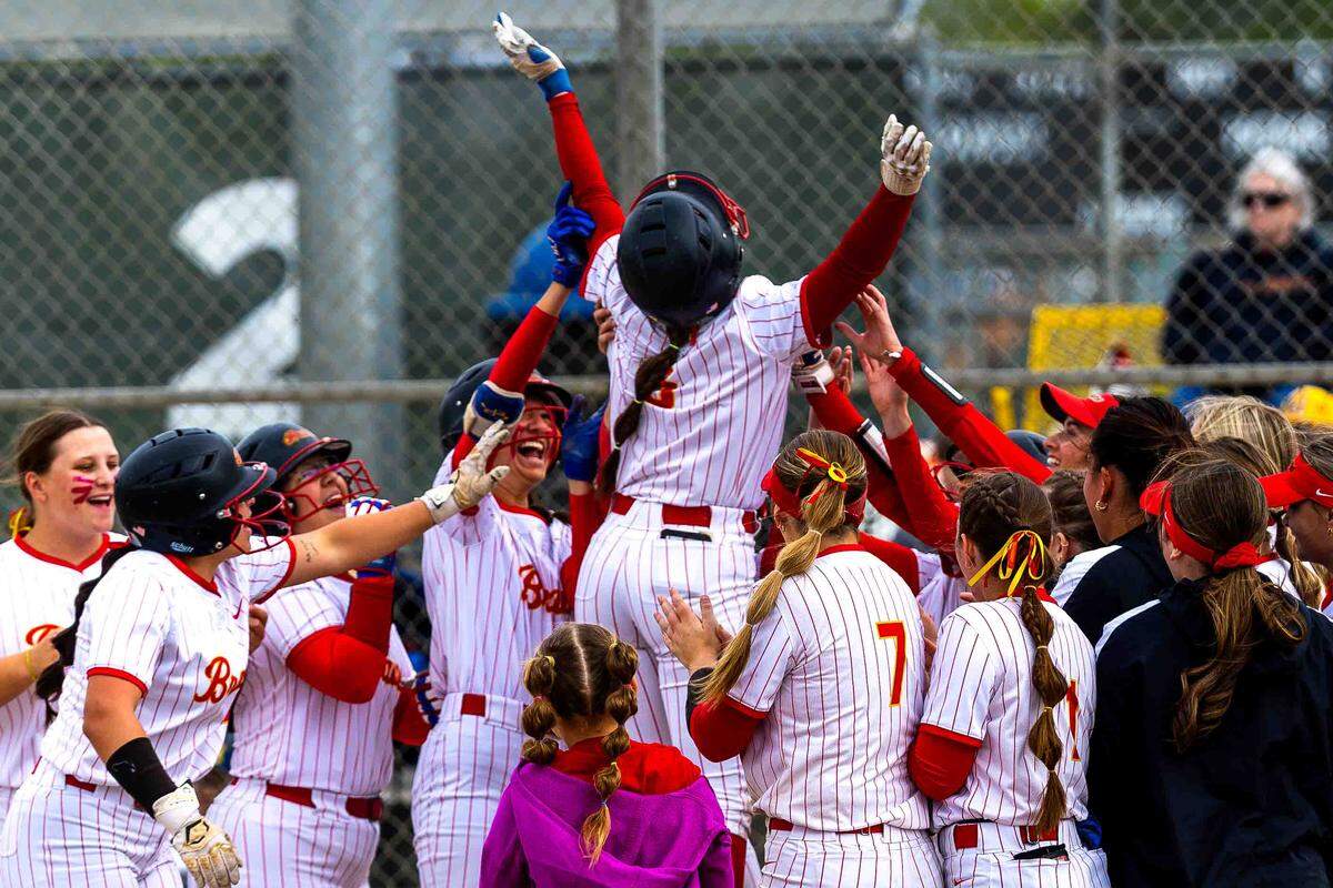 Kamiakin players celebrate with Harley Worster (6) after her home run during Friday’s District 6 playoff victory over Mead at Lawrence Scott Park. 