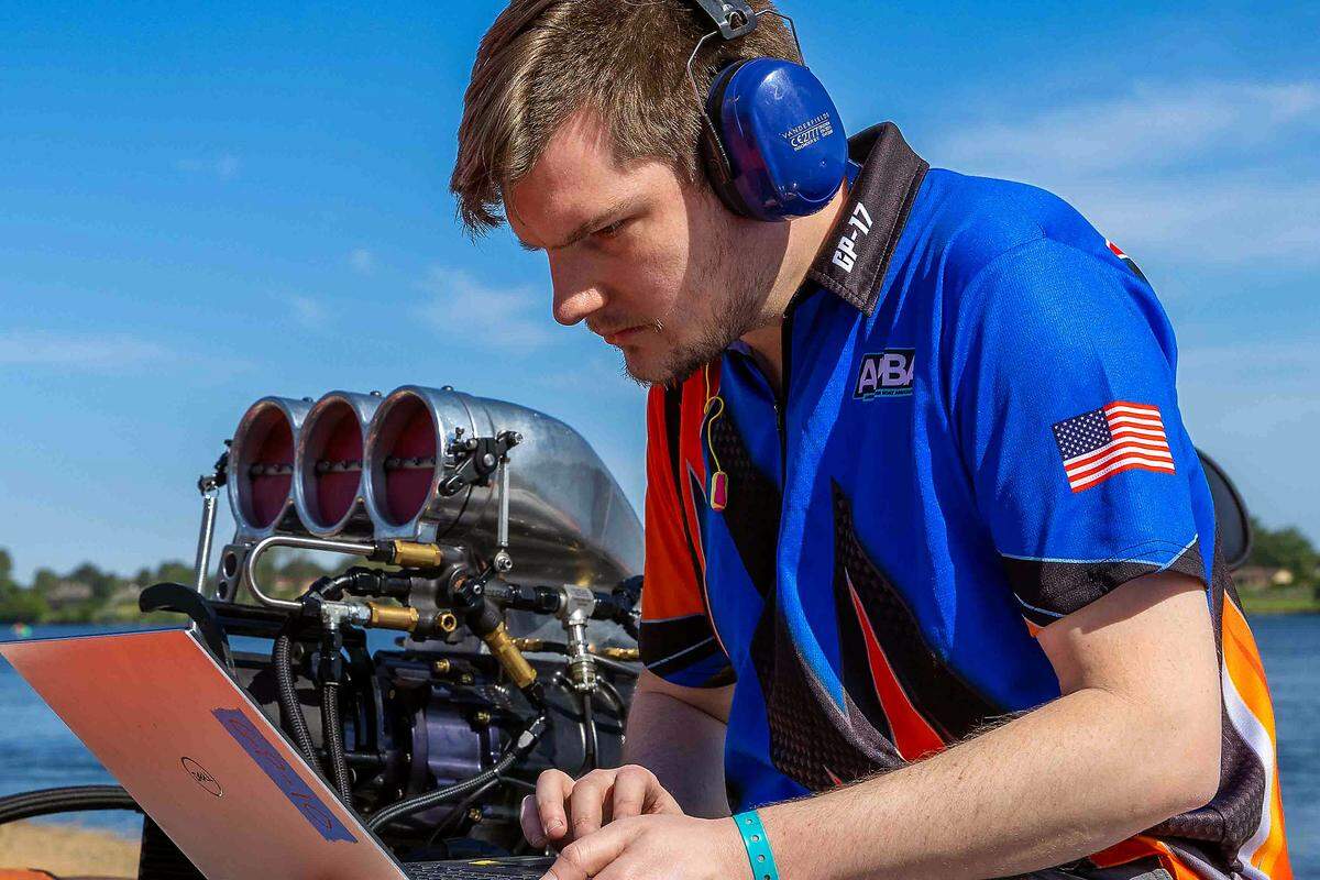 A hydroplane crew member analyzes performance data beside a turbine-powered race boat during spring testing on the Columbia River in Kennewick on Saturday. Modern teams rely on onboard telemetry, computer diagnostics and driver feedback to fine-tune boats ahead of the Columbia Cup races scheduled for July 24-26