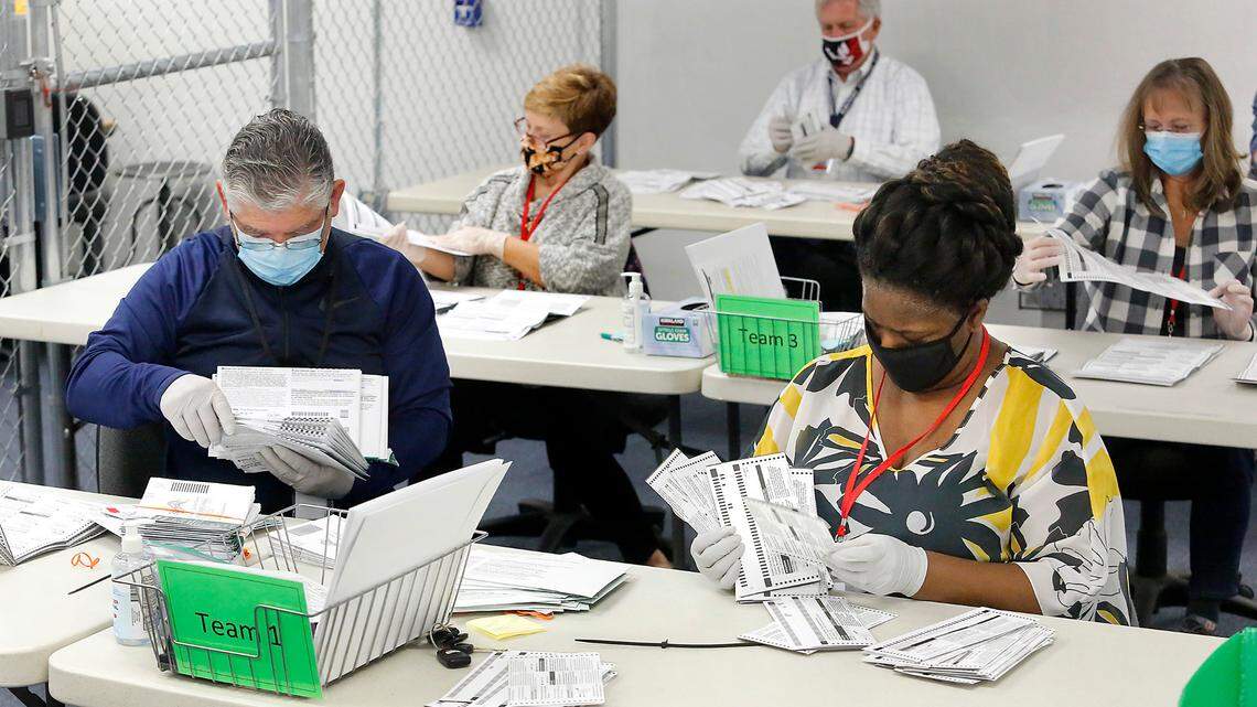 Teams of temporary election workers opened ballot envelopes in this November 2020 file photo before the ballots were scanned at the Franklin County Elections Center in Pasco.