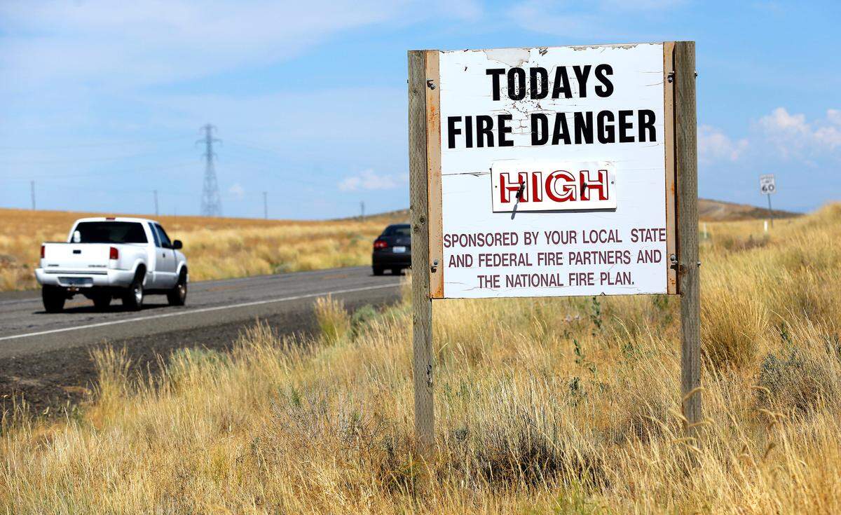 A sign on Highway 397 at Owens Road south of Kennewick warns passing motorists of high fire danger because of the recent extremely high temperatures. The Benton County fire marshal increased the fire danger rating to “very high” on Wednesday.