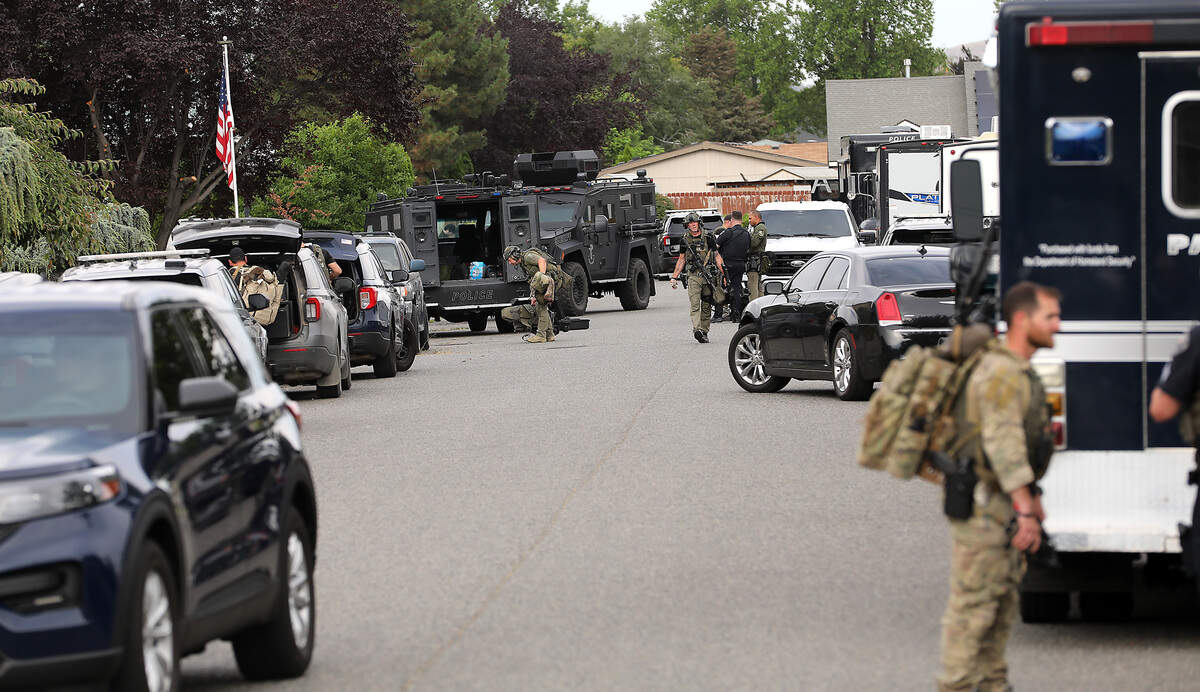 Members of the Tri-City Regional SWAT team wrap up a nearly six hour standoff Tuesday morning in the 4600 block of West Grande Ronde Avenue in Kennewick. Officers took suspect Devon Rex into custody after he allegedly threatened roommates with a knife and then barricaded himself inside a room.