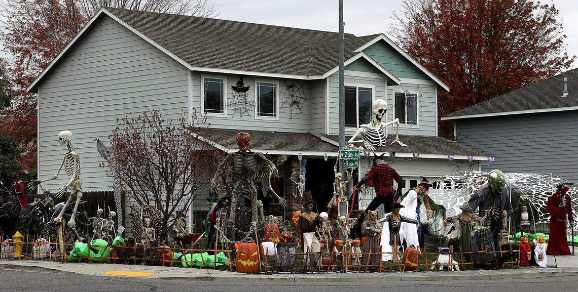 The Osborn front yard on the corner of West 28th Avenue and South Rainier Place in Kennewick is covered with all sorts of spooky displays and colorful lights.