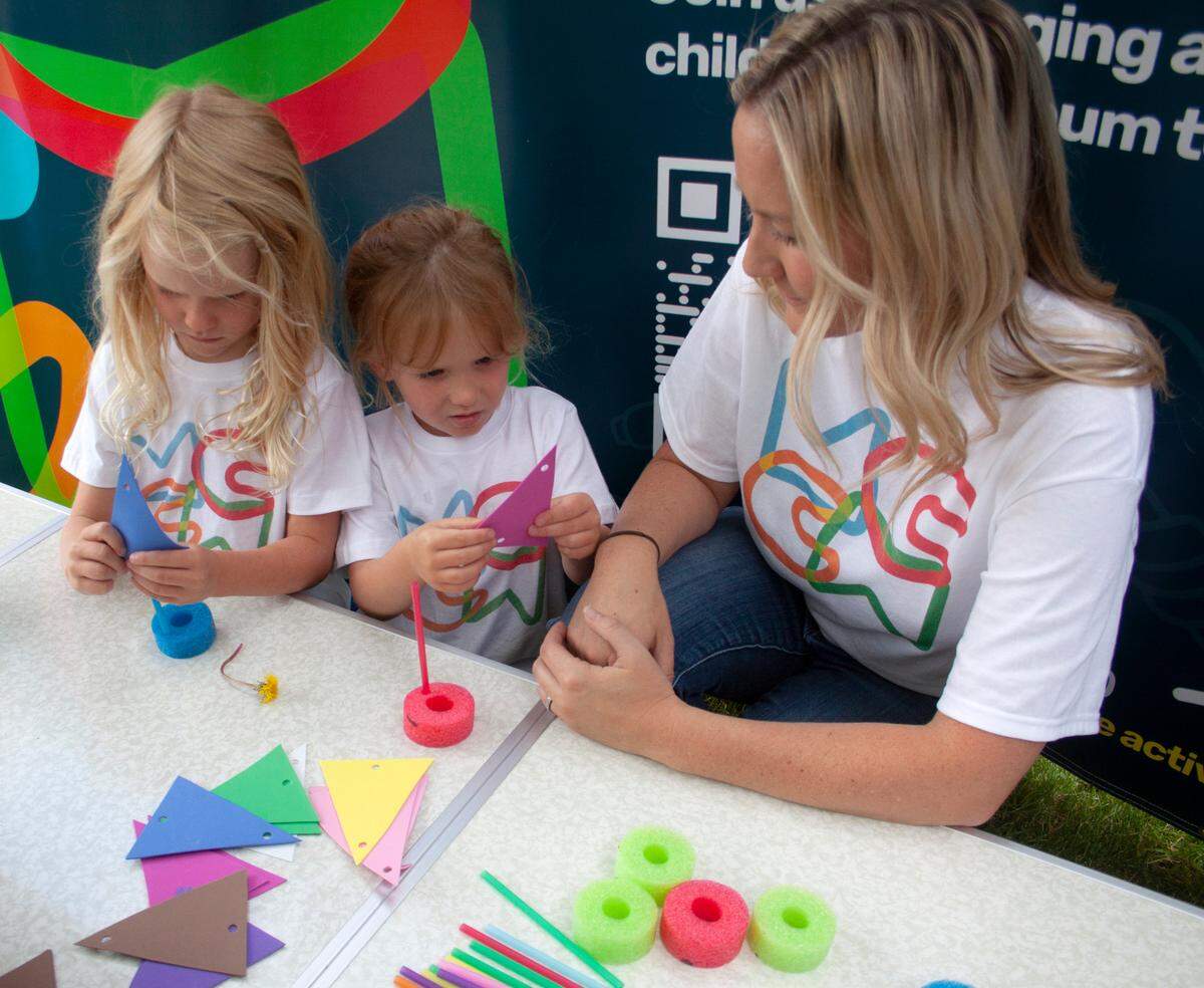 A volunteer with the Mid-Columbia Children’s Museum assists children during a pop up event. A 12-member task force is building support to reestablish a children’s museum in the Tri-Cities.