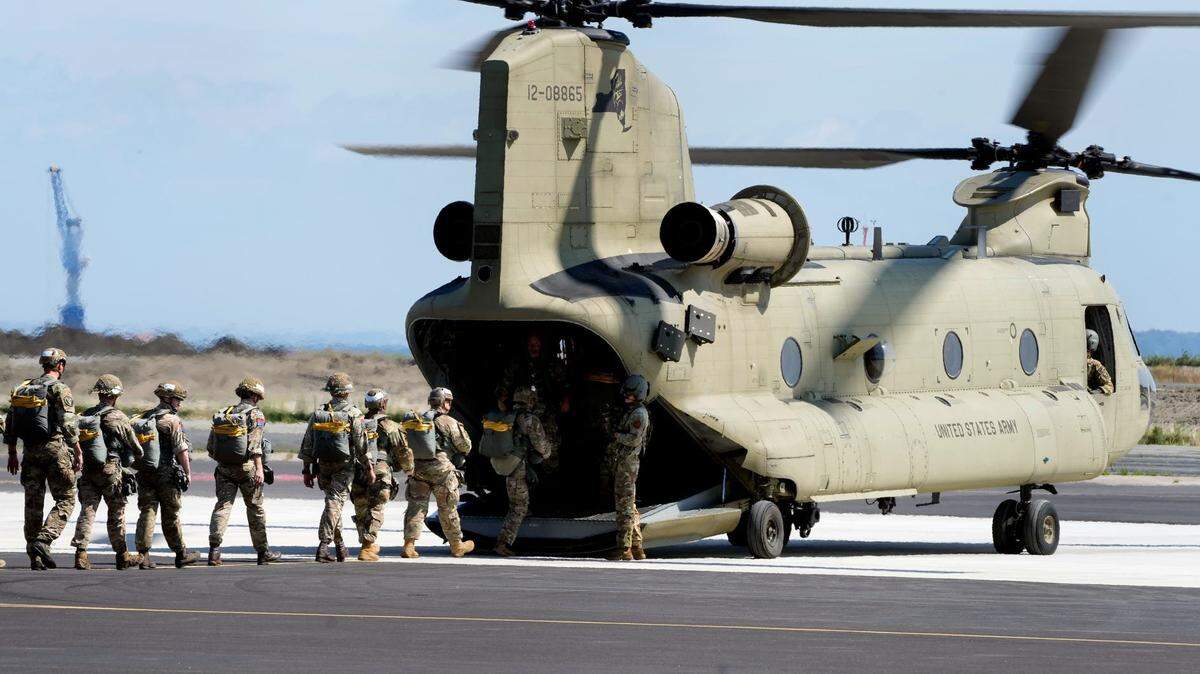 Competitors board a twin-rotor Chinook CH-47 helicopter during the first round of the Leapfest competition Saturday morning.