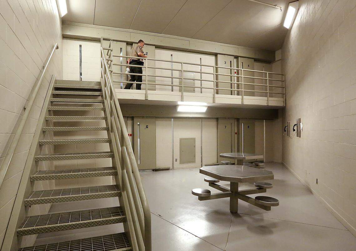 A Benton County sheriff corrections officer inspects an empty pod at the Benton County Jail in Kennewick.