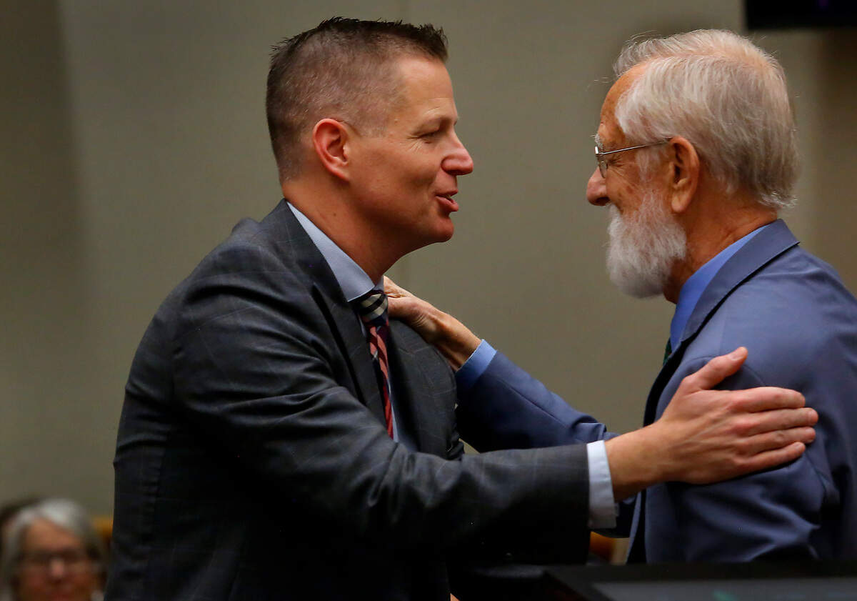 Benton County’s new prosecutor, Eric Eisinger, left, is congratulated by attorney Thomas Heye during the swearing-in ceremony at the Benton County Justice Center in Kennewick.
