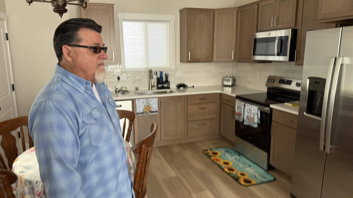 Kevin Gunn of Jacobs and Rhoses heating and Air Conditioning gives a sneak peek of the house fans of Jimmy “Woo-Hoo” Butcher built to replace his water damaged home in Kennewick. The all-new home is complete and will be revealed at 2 p.m, Saturday, March 27.