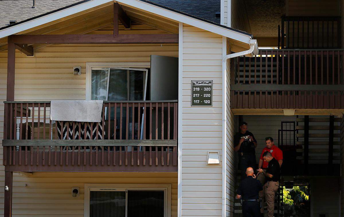 Police investigators stand outside the the second floor apartment at 3703 W. Kennewick Ave during their search for clues into the death of Brandy Ebanez.