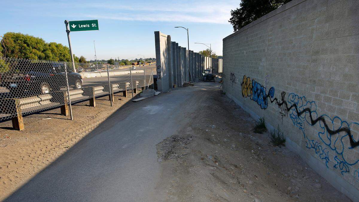 Graffiti mars both sides of the new concrete block sound wall north of the blue bridge on Highway 395 next to the Flamingo Village Mobile Home Village in Pasco.