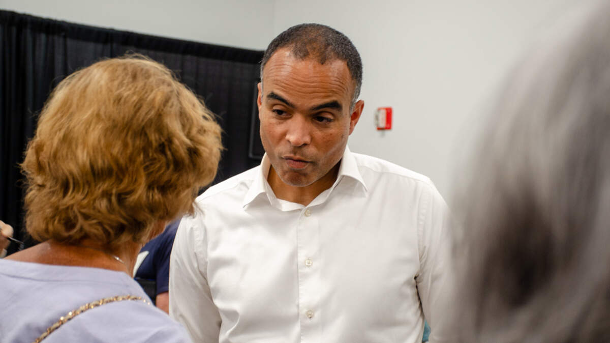 Washington Attorney General Nick Brown speaks to a concerned citizen, Susan McTavish, 76, of Kennewick, about using tax dollars to fund his legal challenges of the Trump administration.