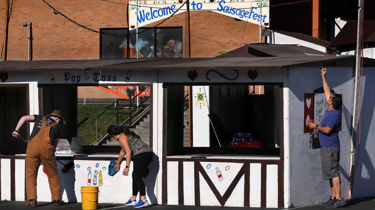 Volunteers Matt Mesick, Andrea Childers and Chris Mulkey, from left, scrub and touch-up a booth for the 47th annual Sausage Fest at the Christ the King Catholic School in Richland. The two-day event kicks off Friday. Admission is free. Hours are Friday 5 p.m.-11 p.m. and Saturday 11 a.m.-11 p.m.