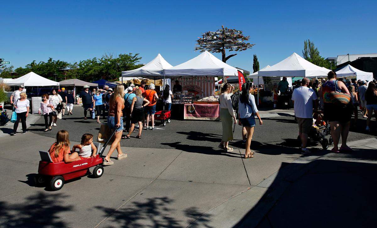 Shoppers and vendors fill the Lee Boulevard roundabout on The Parkway on a Friday morning for the Richland Farmer’s Market. The market offers a wide variety of fresh fruits, vegetables, meats, baked goods, flowers and crafts for sale. It’s open every Friday June through October, weather permitting.