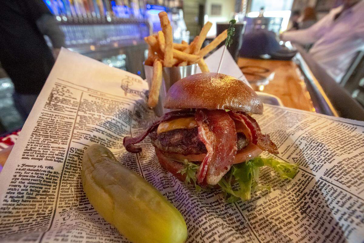 Silo’s bacon burger with premium Washington beef, bacon, American cheese and Silo sauce served with fries and a pickle.