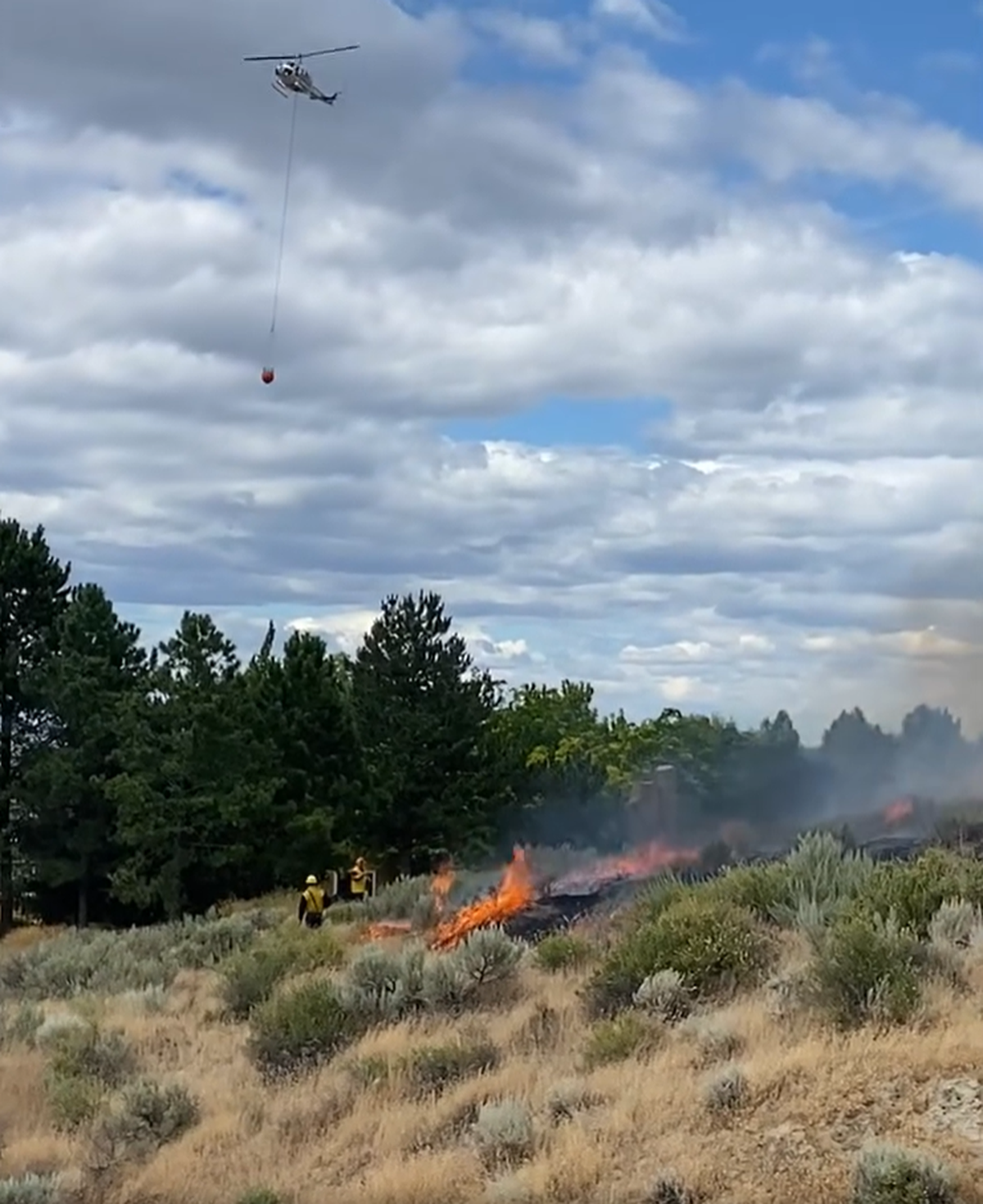 A Department of Natural Resources helicopter dropped water on the Columbia River Road fire Monday afternoon.